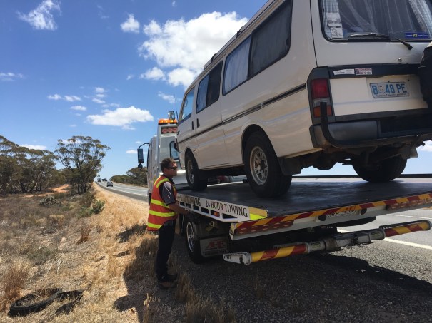 Broken down campervan on a truck