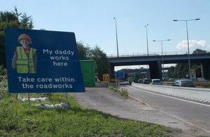 Slow down for roadworks sign 